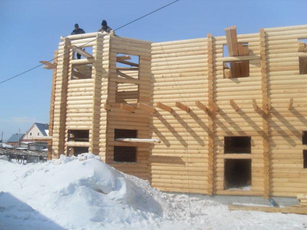 بناء منزل من الخشب في فصل الشتاء.